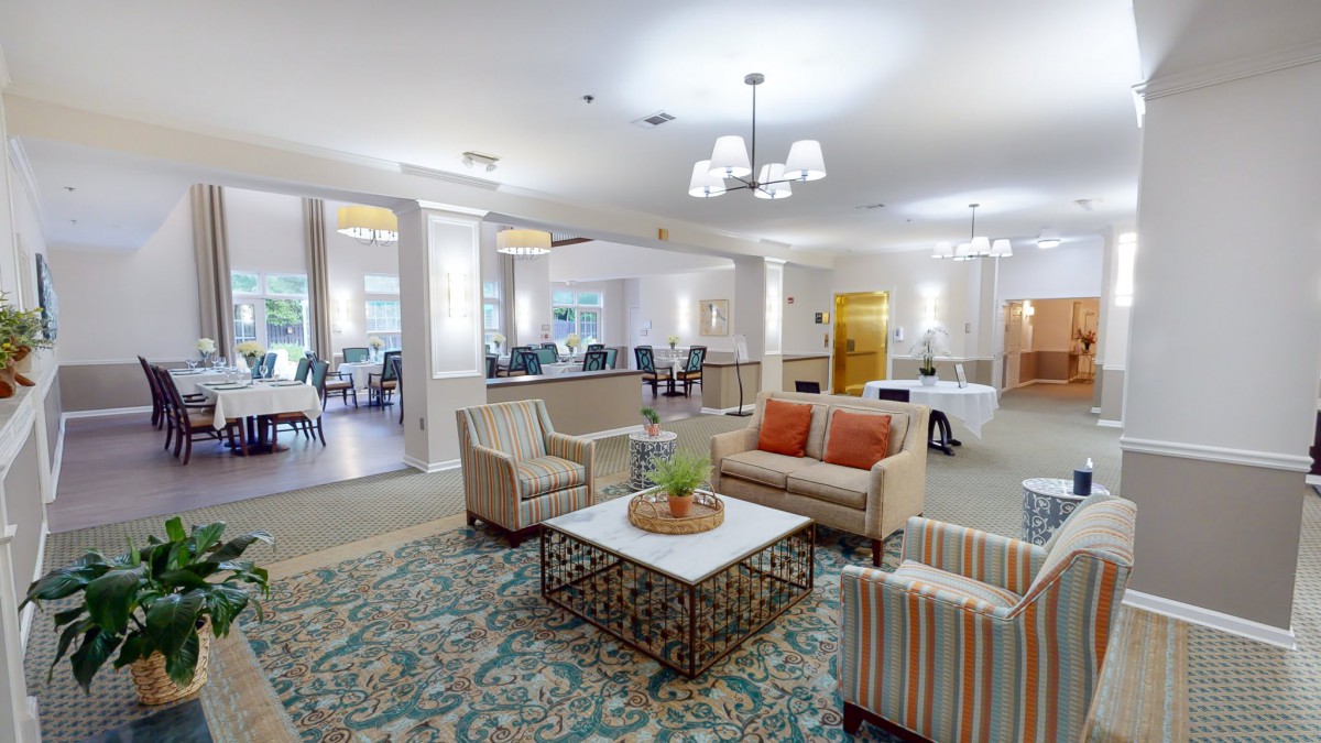 A modern living room featuring comfortable seating, stylish furniture, and elegant lighting.