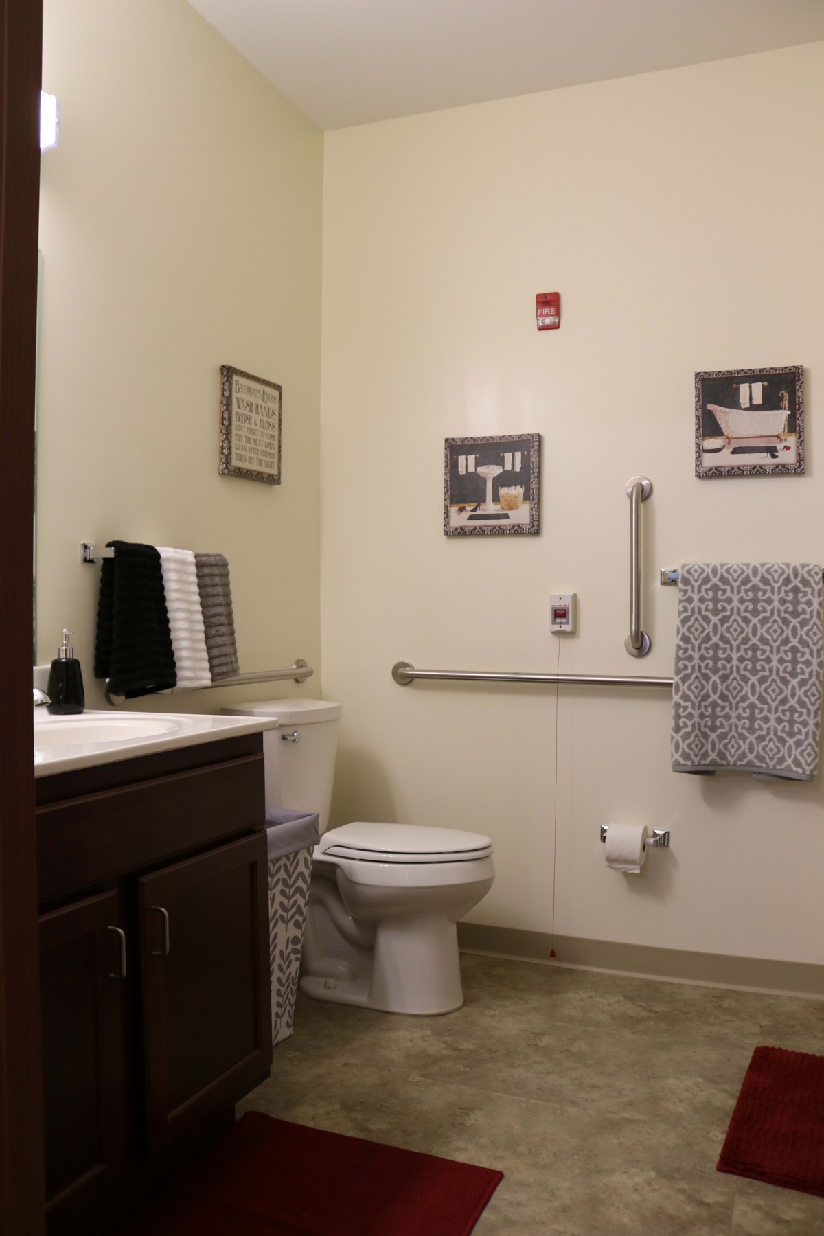 A well-organized bathroom with wall decor and accessible features.