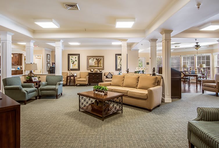 A spacious living room with comfortable seating and elegant decor.