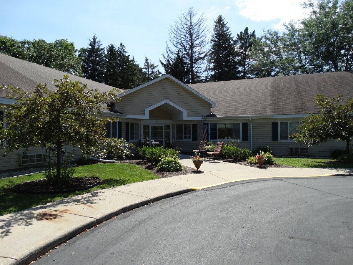 A suburban house with a landscaped front yard and driveway.