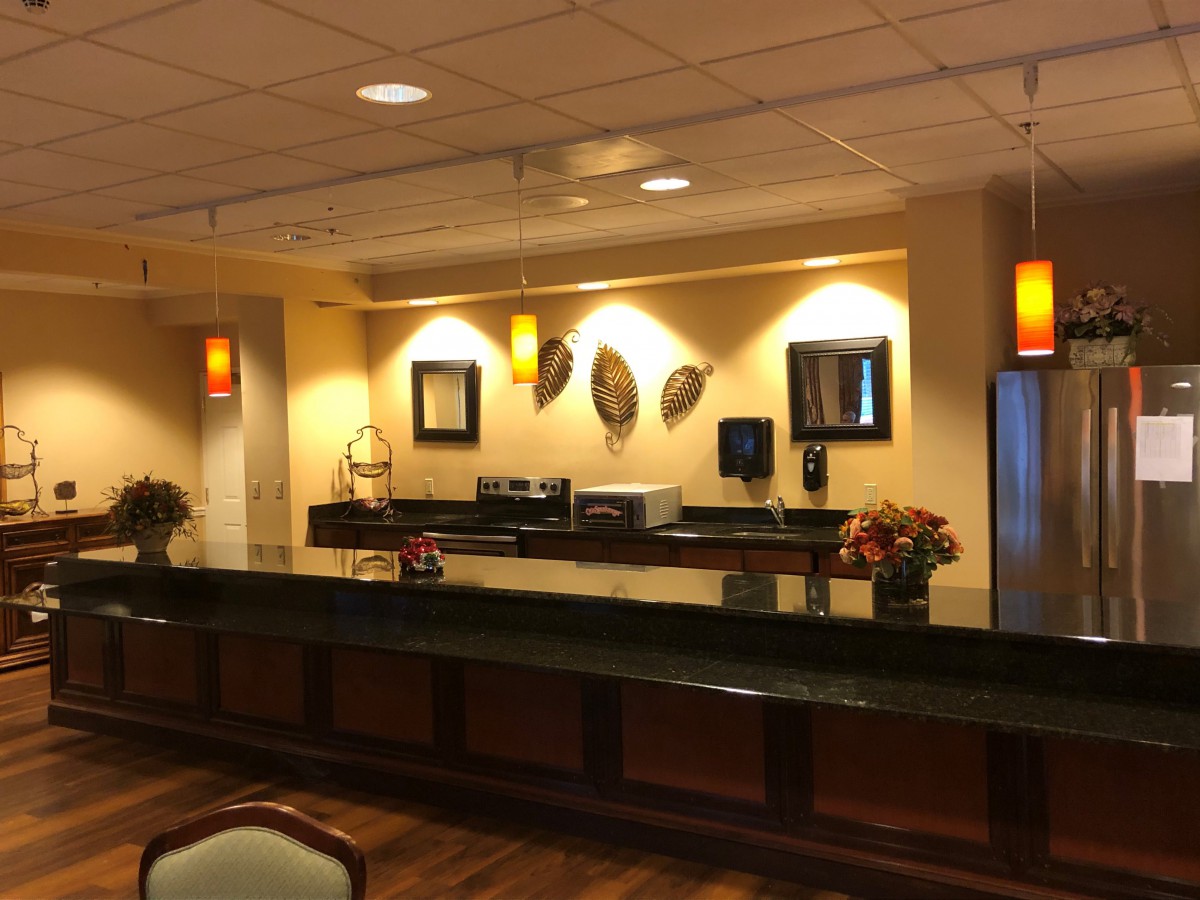 A well-lit reception area with decorative accents and a polished counter.