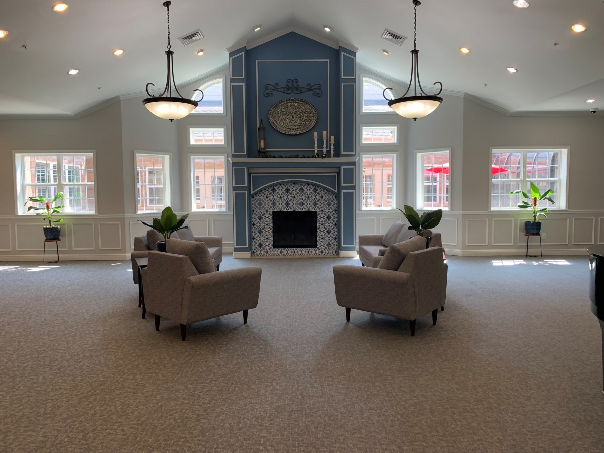 A cozy living room featuring a fireplace and elegant armchairs.