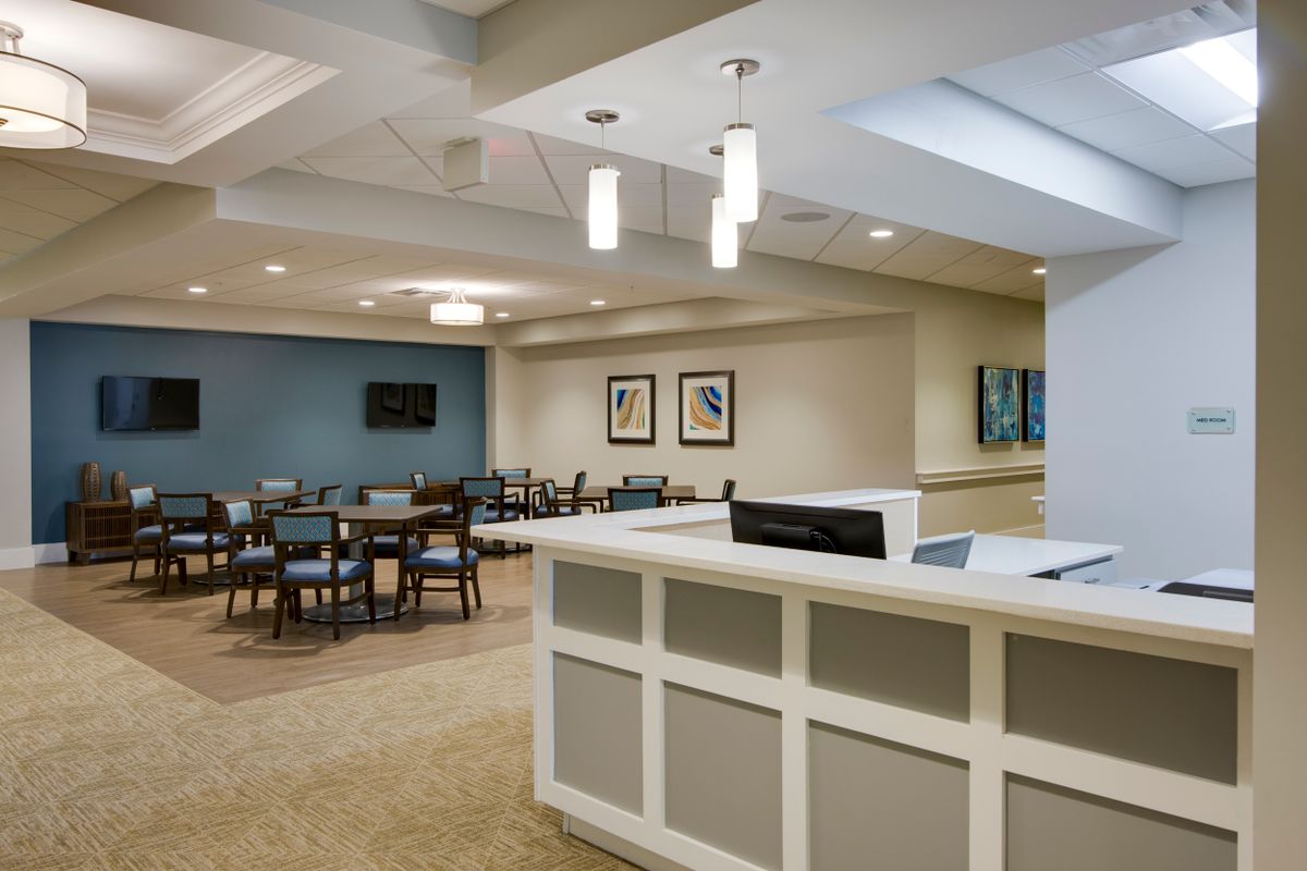 A modern reception area with seating and contemporary lighting.