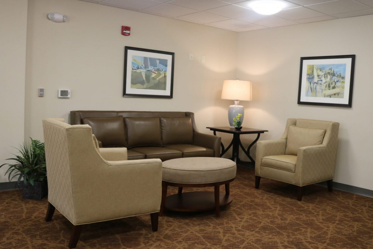 A cozy waiting room with comfortable seating and warm lighting.