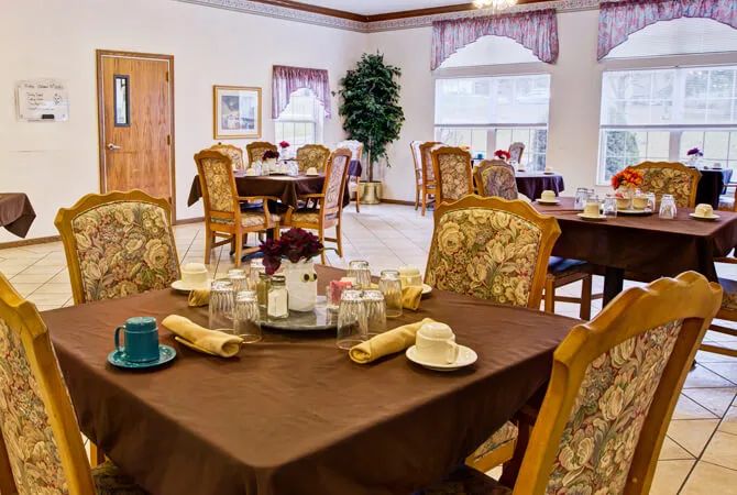Elegantly set dining area with ornate chairs and tables.