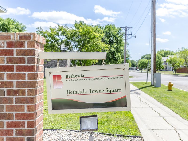 A sign for Bethesda Towers Square on a sunny day.