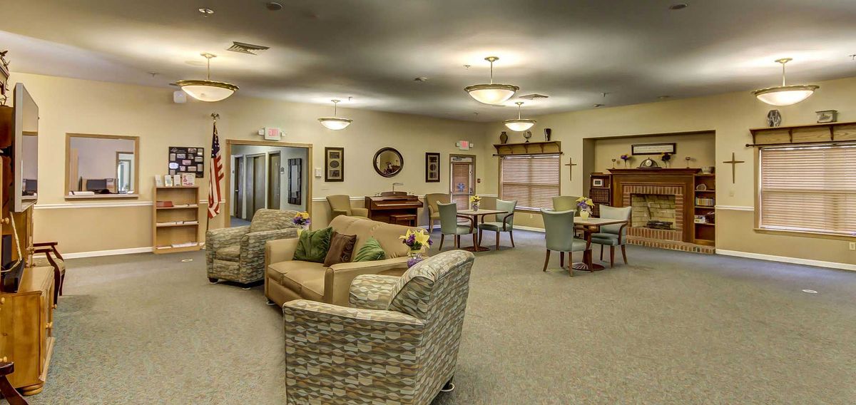 A spacious and well-furnished living area with comfortable seating and elegant lighting.