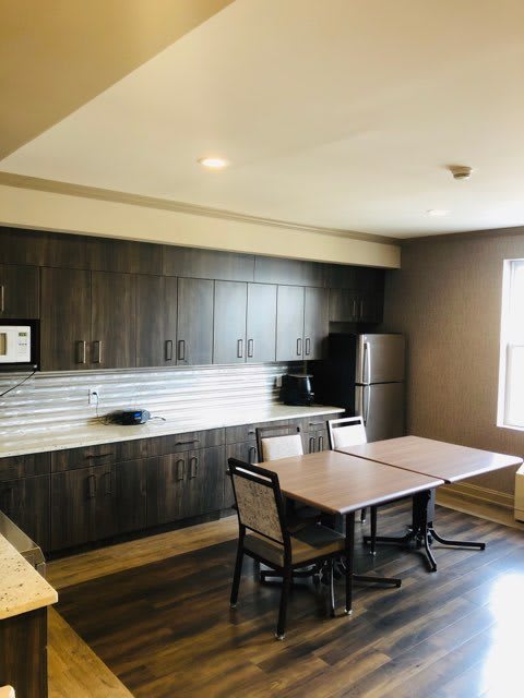 A modern kitchen and dining area with sleek cabinets and contemporary furniture.