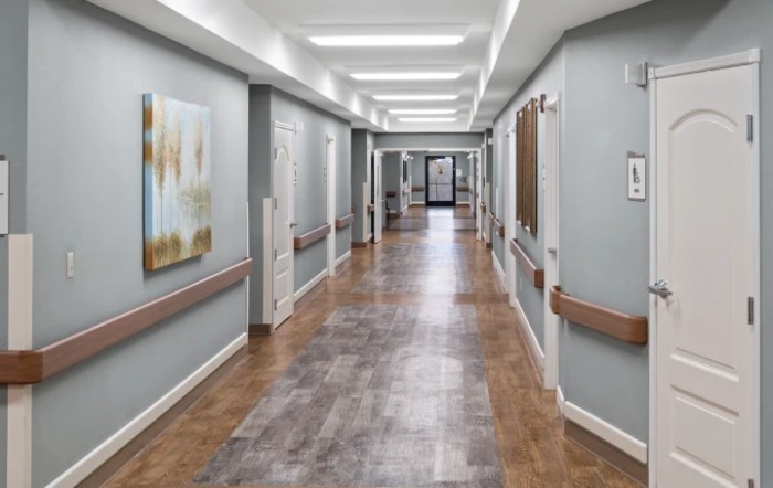 A clean and modern hospital hallway with artwork on the walls.