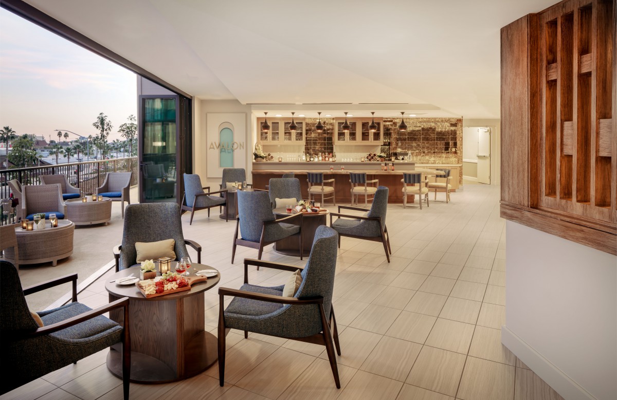 A modern hotel lounge with comfortable seating and a bar area.