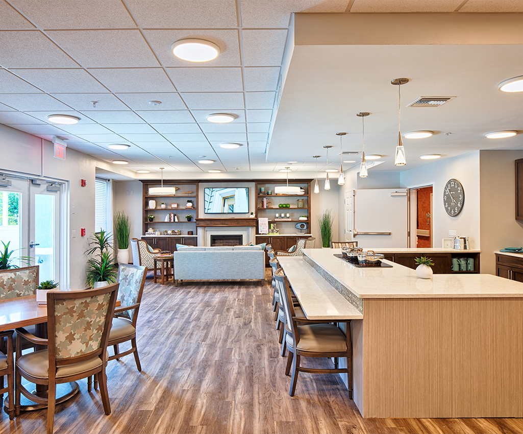 A modern lounge area with comfortable seating, a bar counter, and warm lighting.