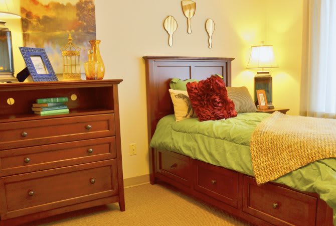Cozy bedroom setup with wooden furniture and warm lighting.