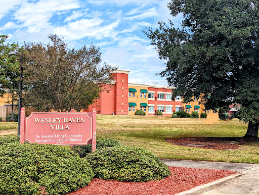 Wesley B. Jones Villa, a community residential building set against a beautiful sky.