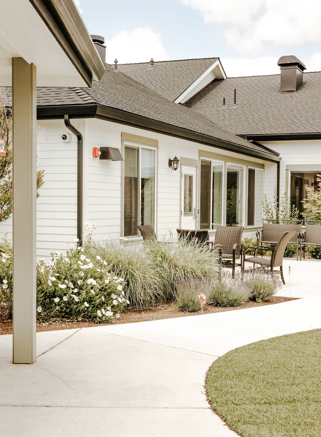 A suburban house with a well-maintained garden and outdoor seating area.