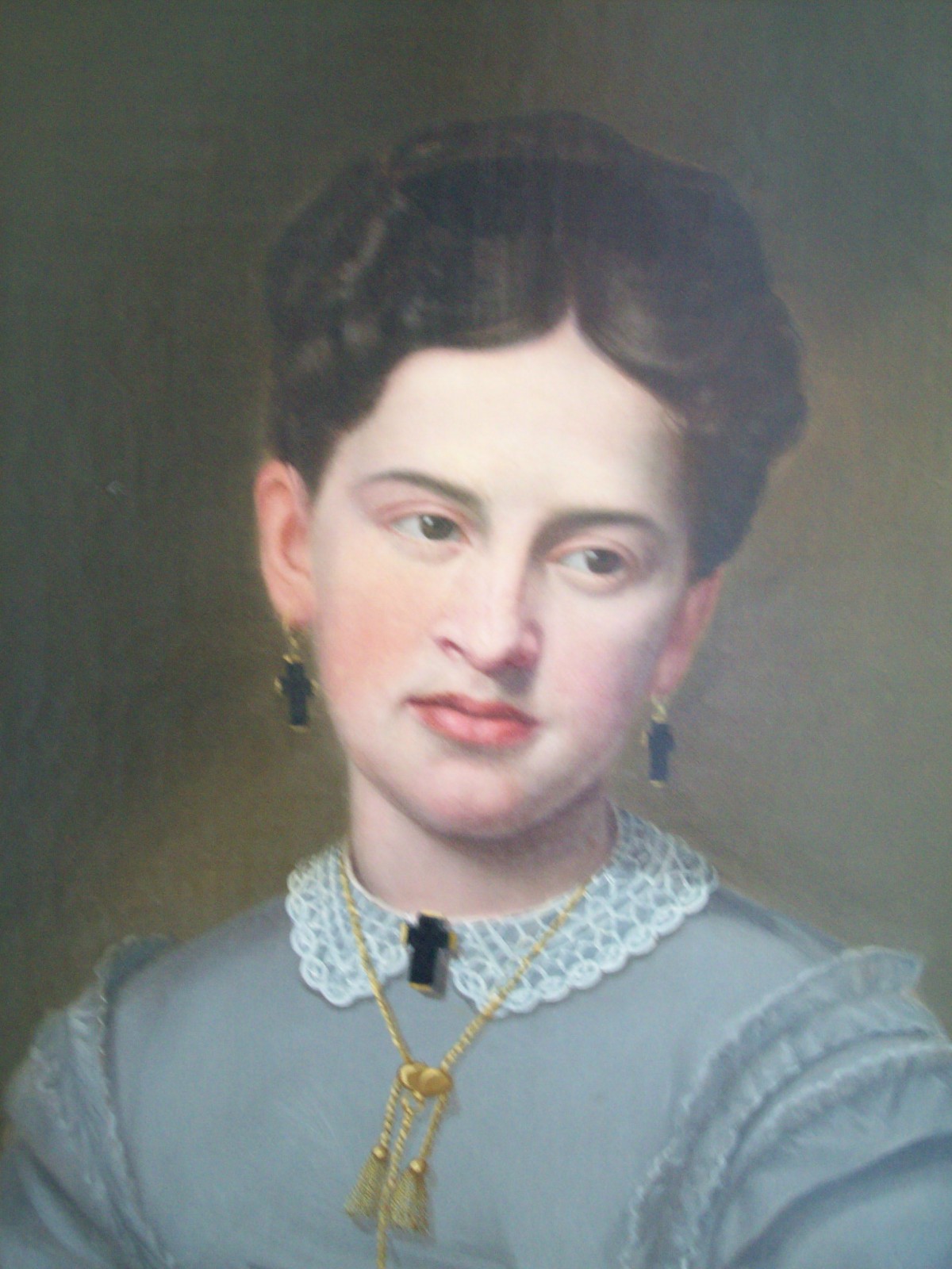 A 19th-century portrait of a woman in classic attire with a lace collar and jewelry.