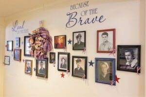 A tribute wall featuring photographs of military veterans, honoring their service.