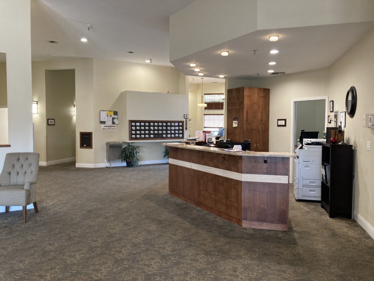 A modern reception area with a spacious desk and seating.