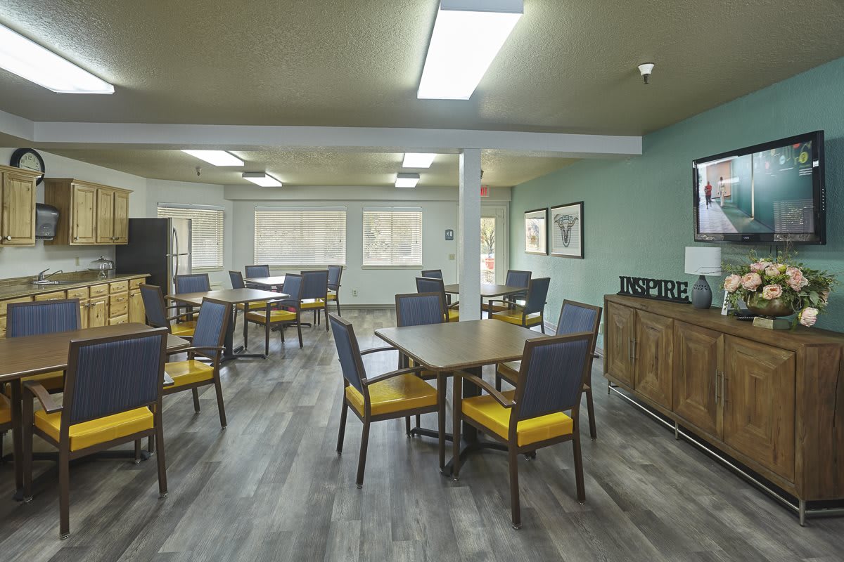 An empty dining area with tables and chairs arranged neatly.
