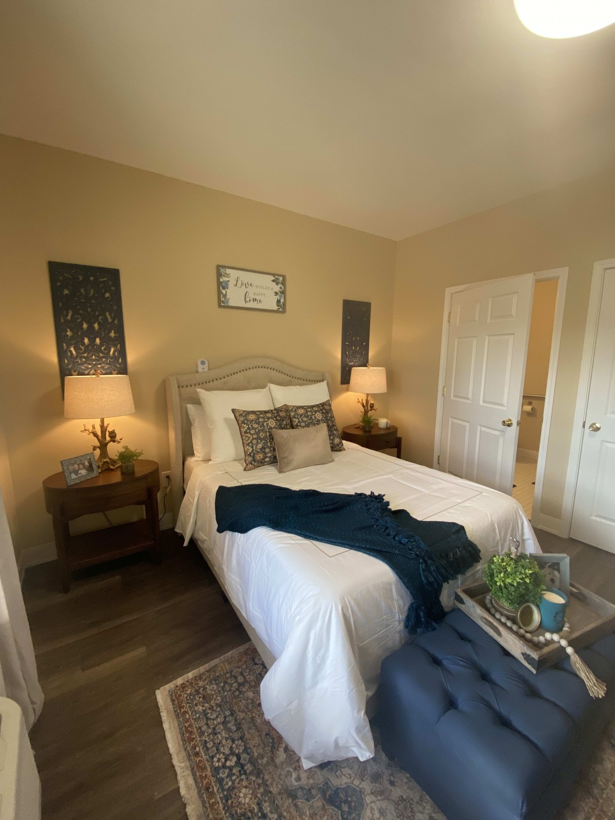 A cozy bedroom with elegant decor and warm lighting.