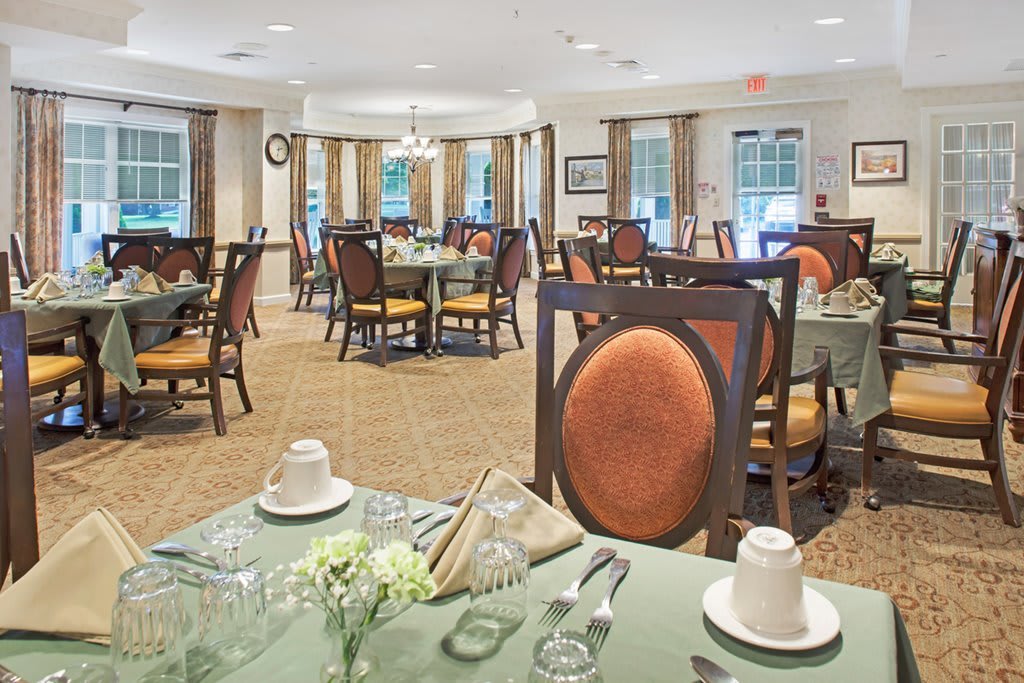 An elegant and spacious dining room with neatly arranged tables and chairs.