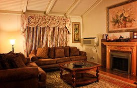 A cozy living room with a sofa, coffee table, and a fireplace.