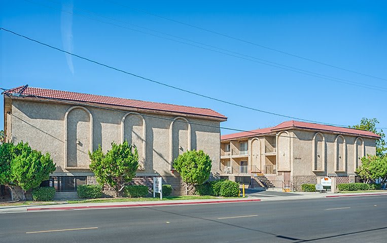 An apartment building with a clear blue sky in the background.