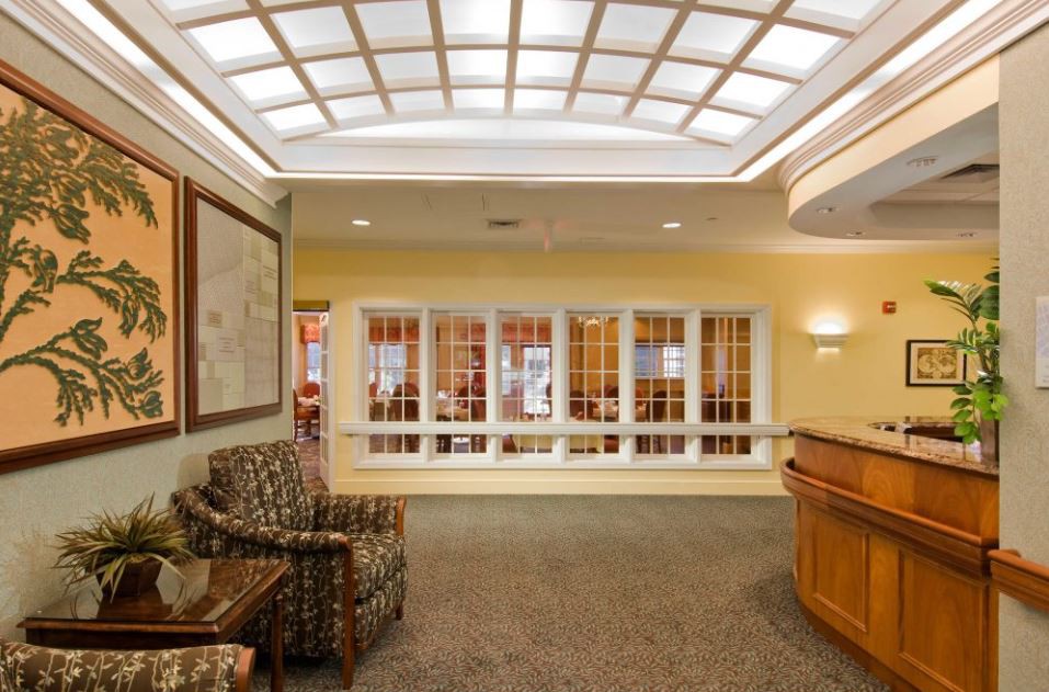A well-lit lobby with comfortable seating and a reception desk.
