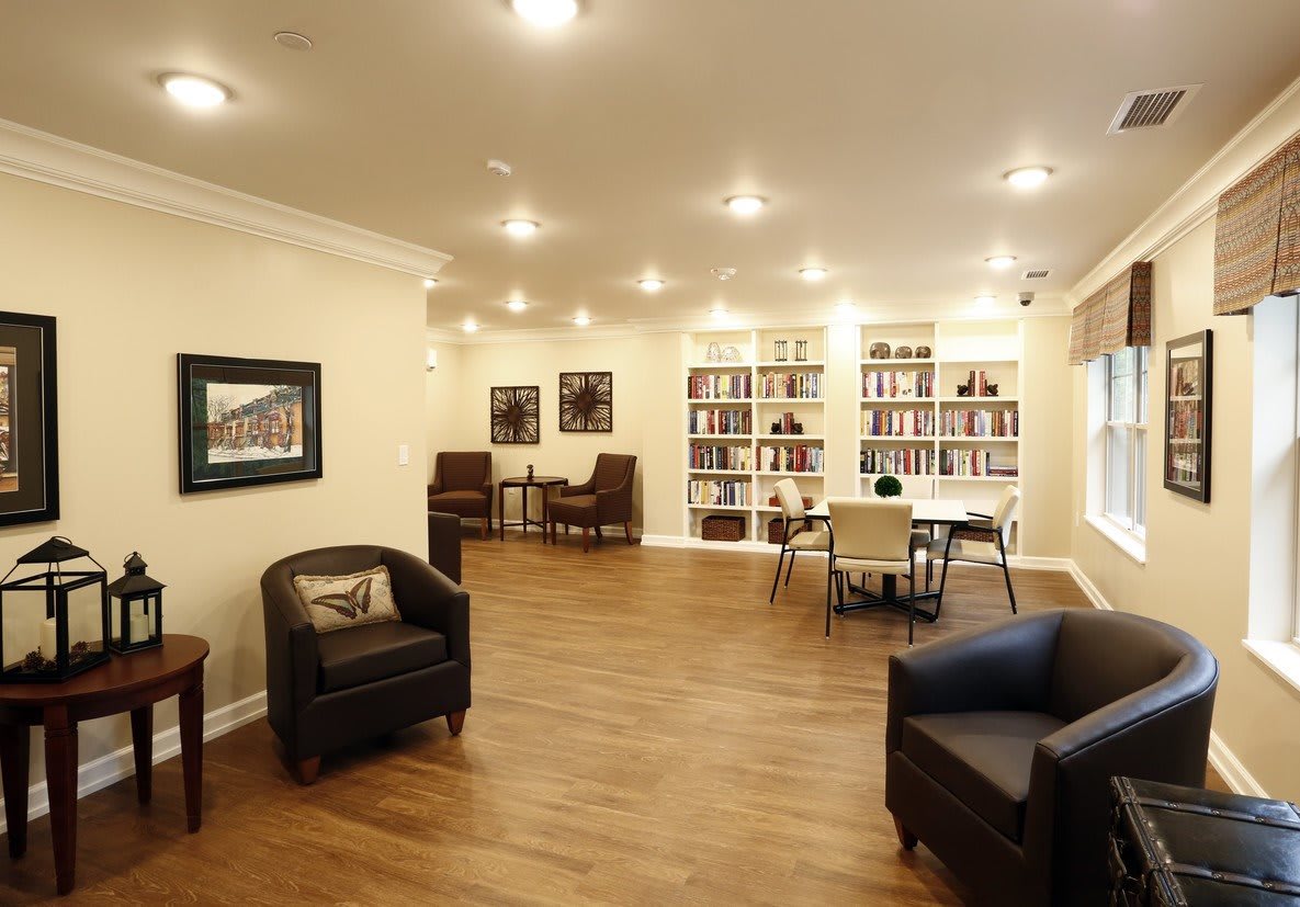 A cozy living room with comfortable seating and bookshelves.