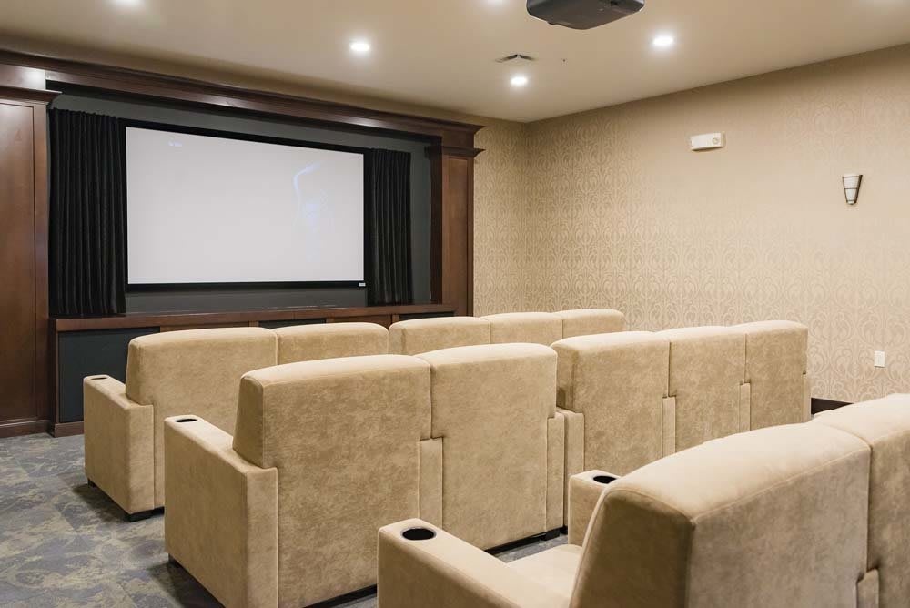 A cozy home theater setup with comfortable seating and a large screen.