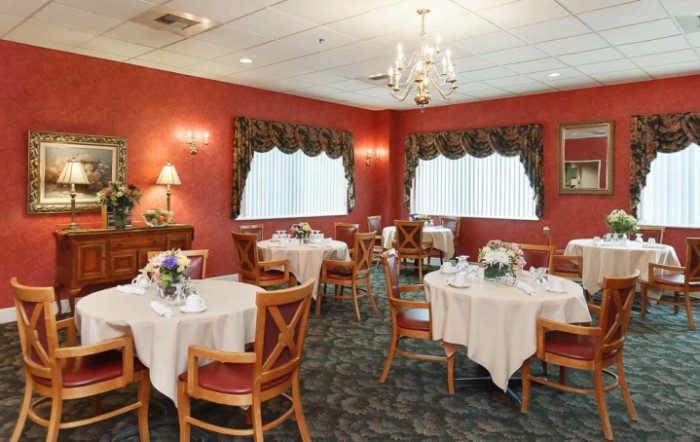 A cozy restaurant dining area with elegantly set tables and a warm ambiance.