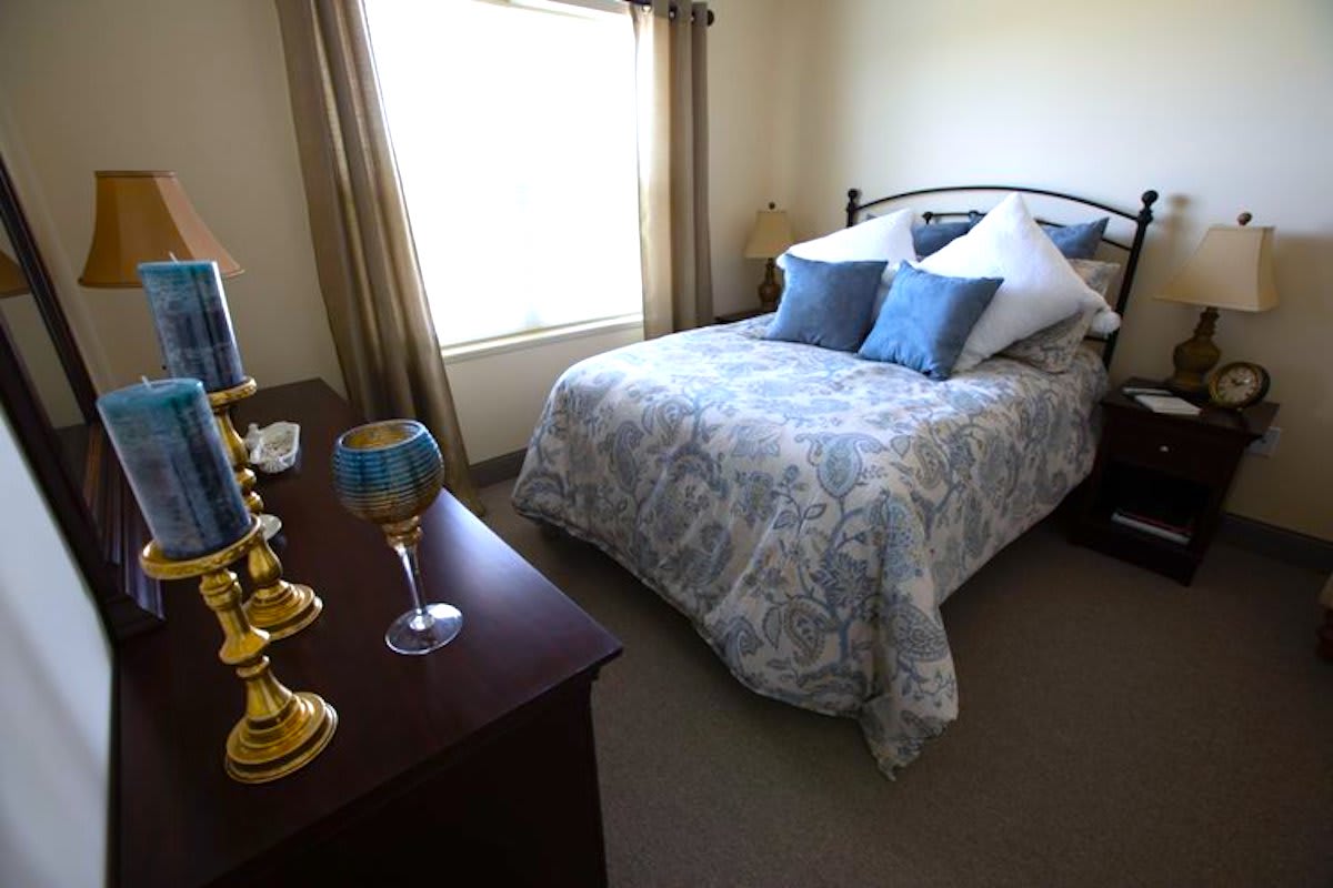 A cozy bedroom with elegant decor and natural light from a window.