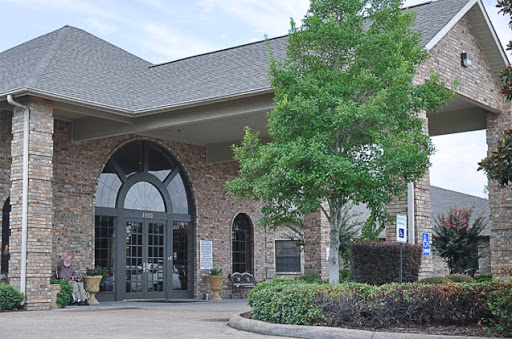 A beautifully designed building with an inviting entrance surrounded by greenery.