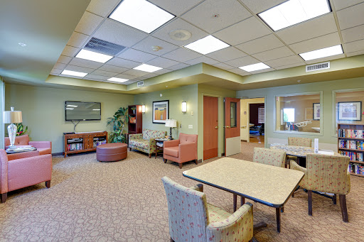 A cozy and inviting lounge area designed for relaxation and waiting, featuring comfortable seating and a warm ambiance.