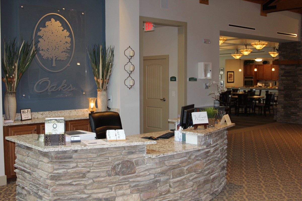 A welcoming hotel reception desk with modern decor and warm lighting.