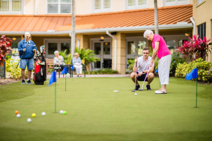 Seniors enjoying a leisurely day on the putting green.