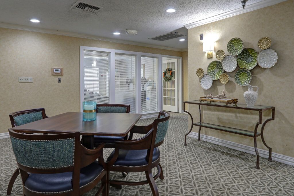 A cozy dining area with a table and chairs, adorned with decorative plates on the wall.