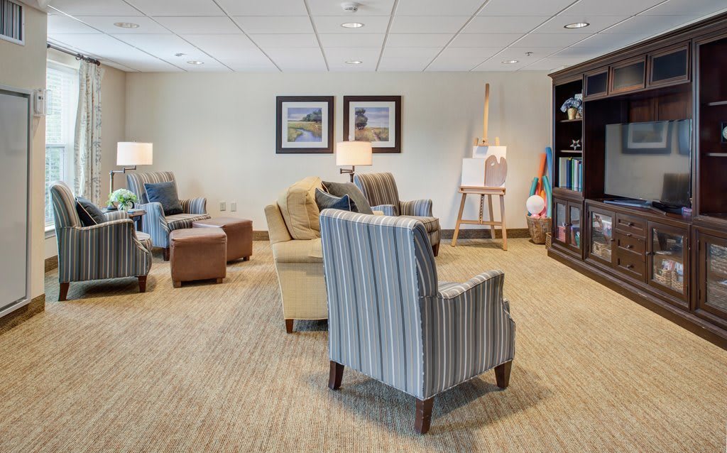 A cozy lounge area with comfortable seating and a bookshelf.