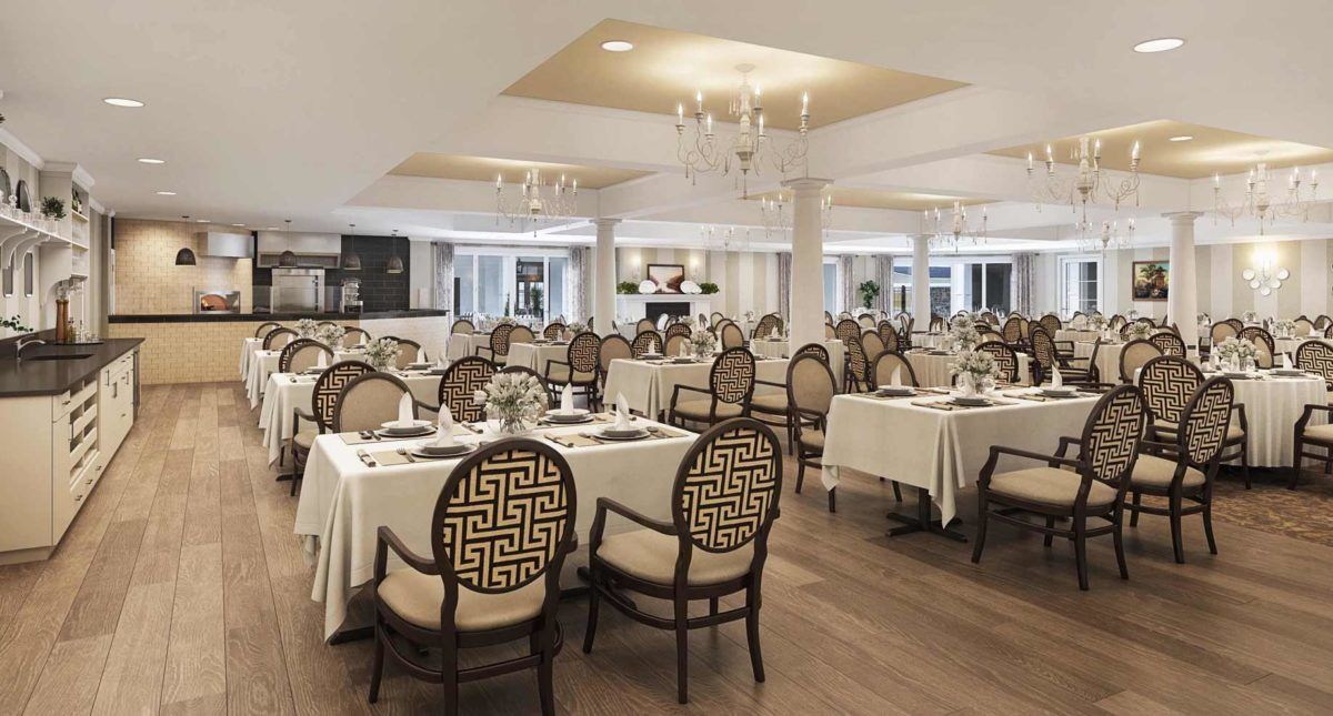 An elegant restaurant dining area featuring ornate chandeliers and finely set tables.