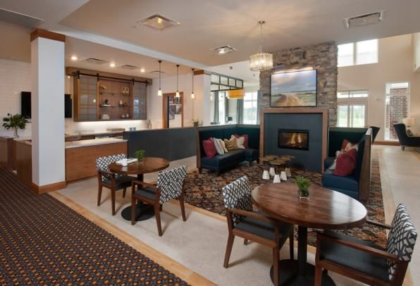 A modern living room with comfortable seating, a fireplace, and stylish decor.