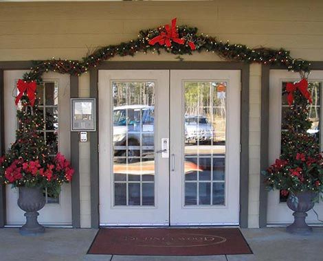 A festively decorated entrance with Christmas wreaths and garlands.