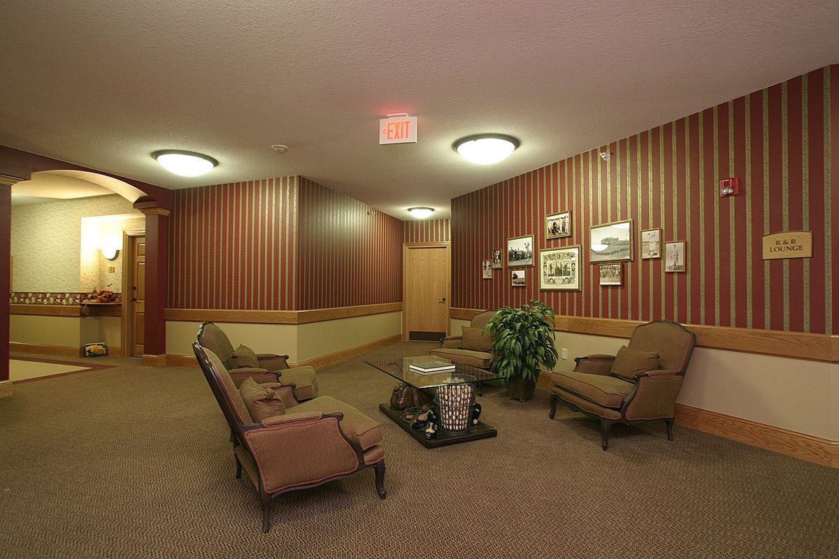 A cozy hotel lobby featuring comfortable seating and decorative wall art.