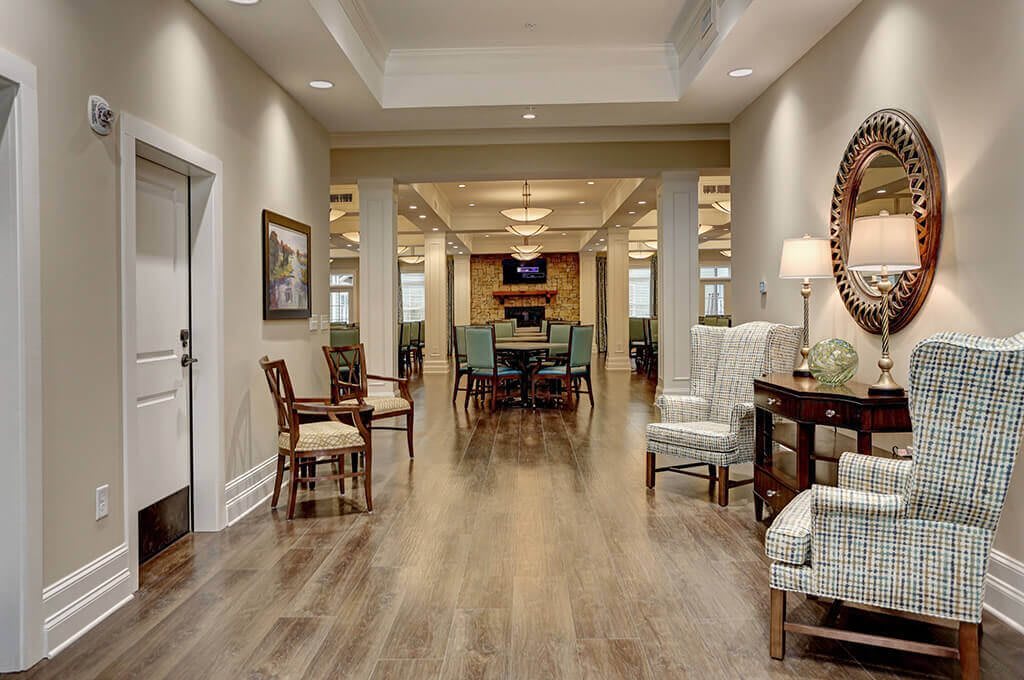 A spacious and elegantly decorated hallway leading into a cozy living area.
