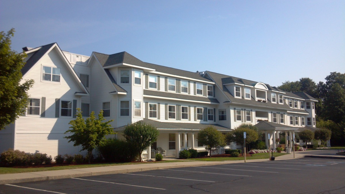 A row of residential apartment buildings under a clear blue sky.