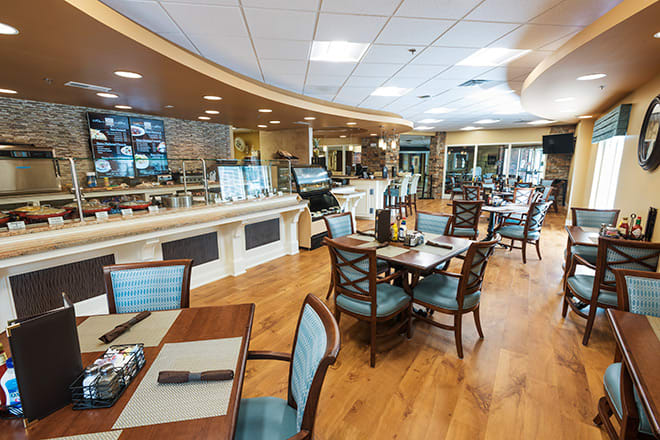 A modern restaurant interior with neatly arranged tables and chairs.