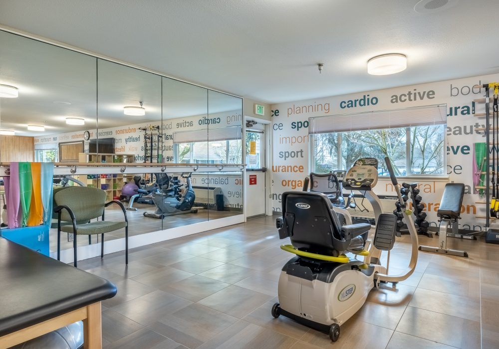 A well-equipped fitness center featuring stationary bikes and mirrored walls.