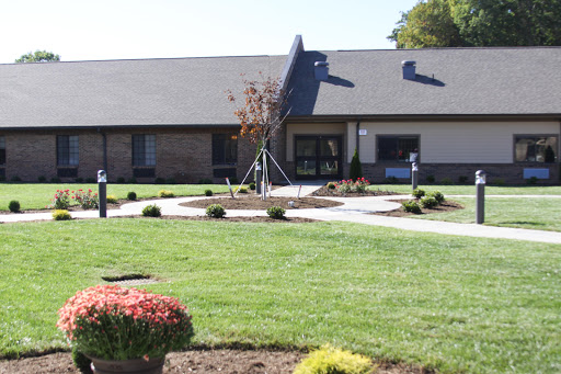 A well-maintained building surrounded by landscaped gardens.