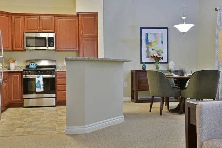 A modern kitchen and dining area with stainless steel appliances and contemporary furnishings.