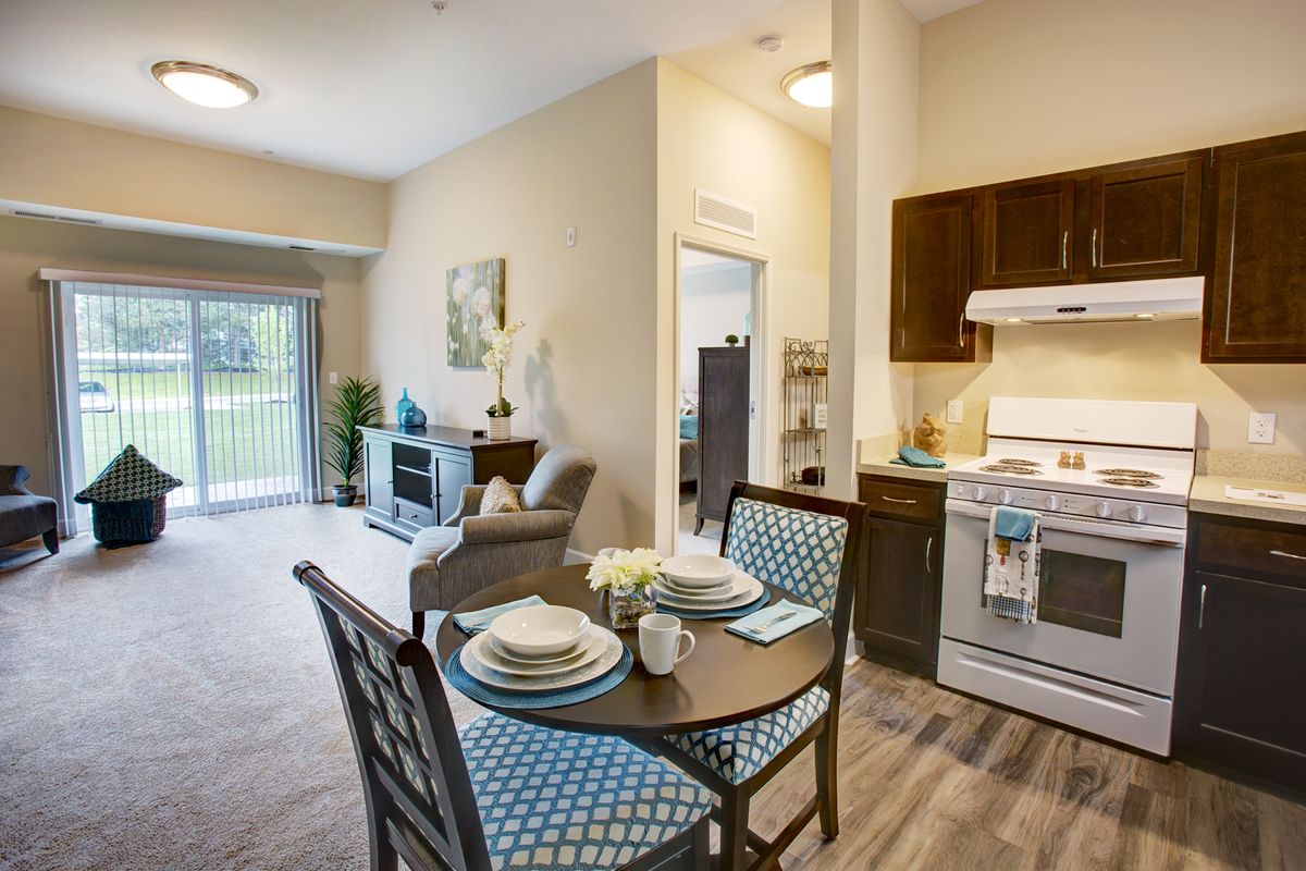 Modern open-layout apartment with a kitchen, dining area, and living room.