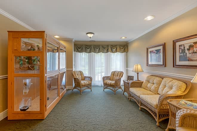 A cozy living room with comfortable seating and natural light from a large window.