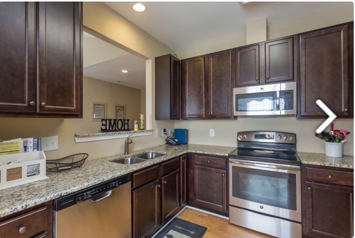 A modern kitchen with stainless steel appliances and granite countertops.
